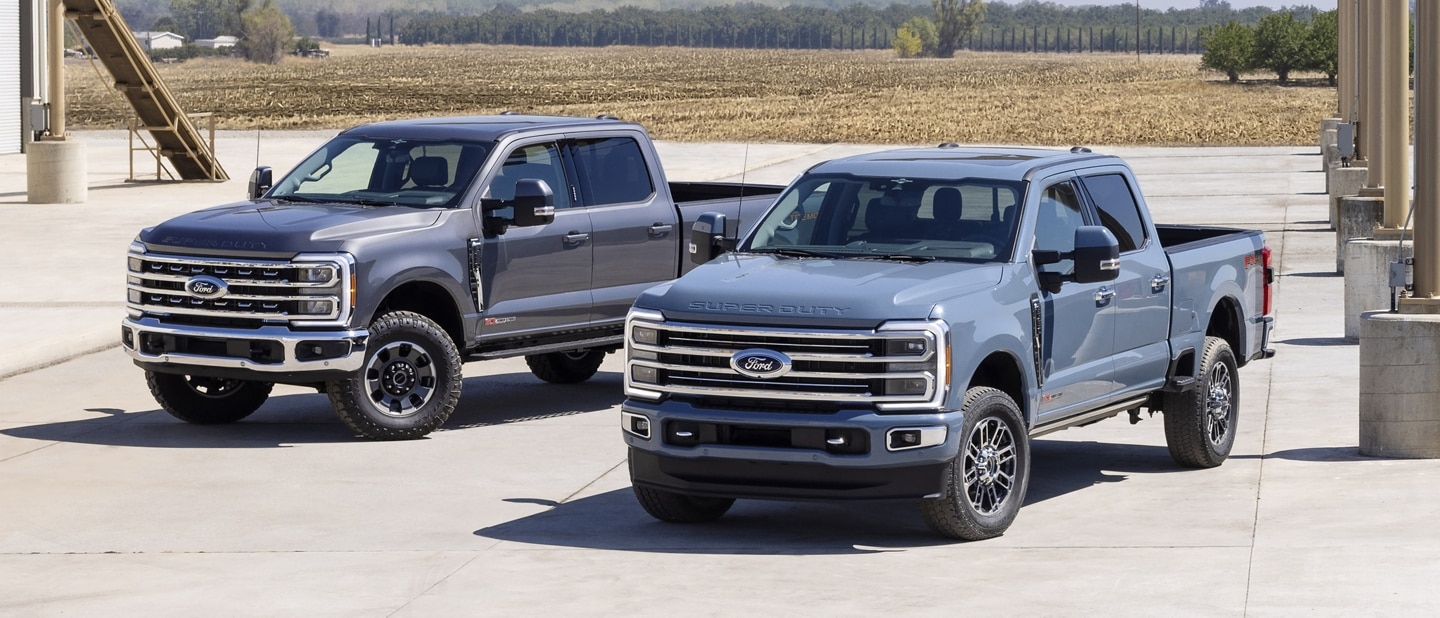 Two 2023 Ford Super Duty® trucks parked side by side