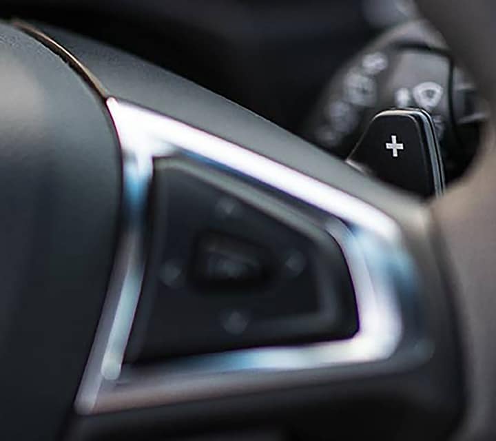 Close-up of paddle shifter on steering wheel