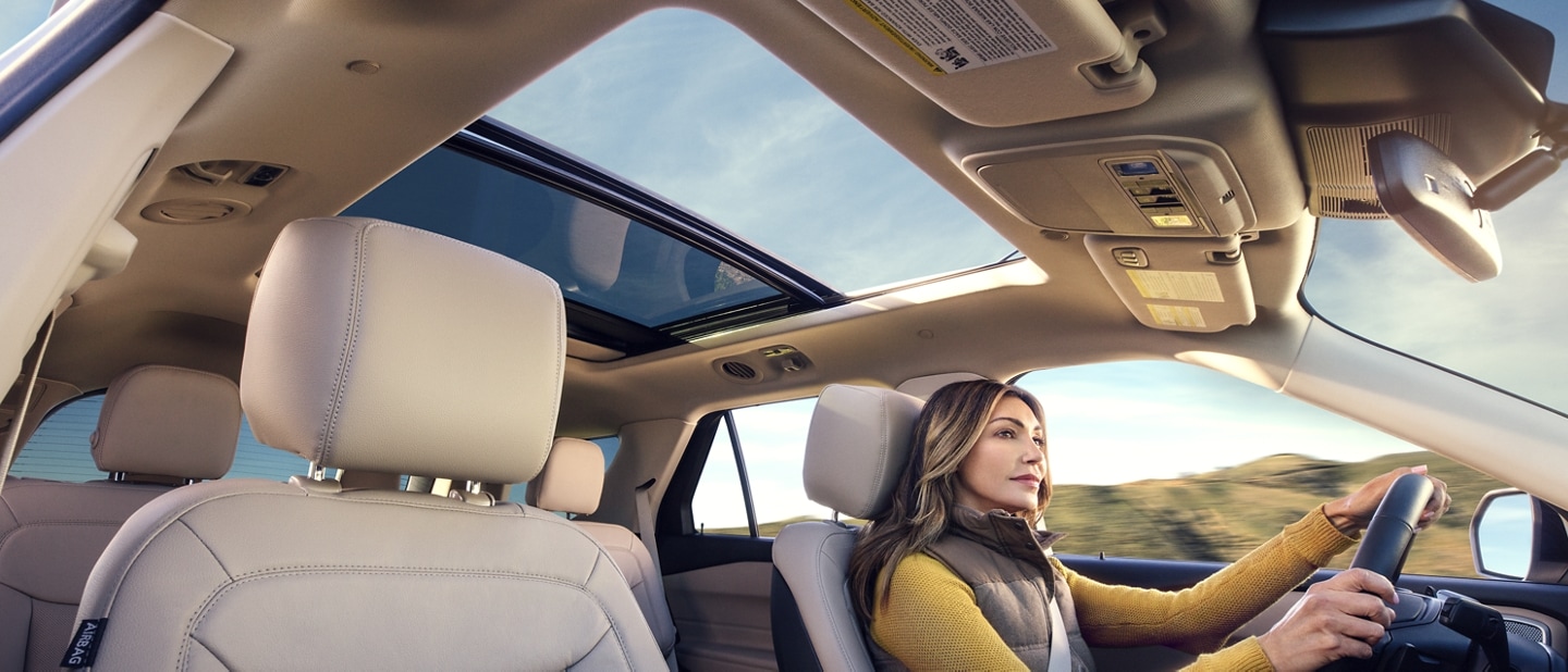 2022 Ford Explorer with a twin-panel moonroof and woman driving