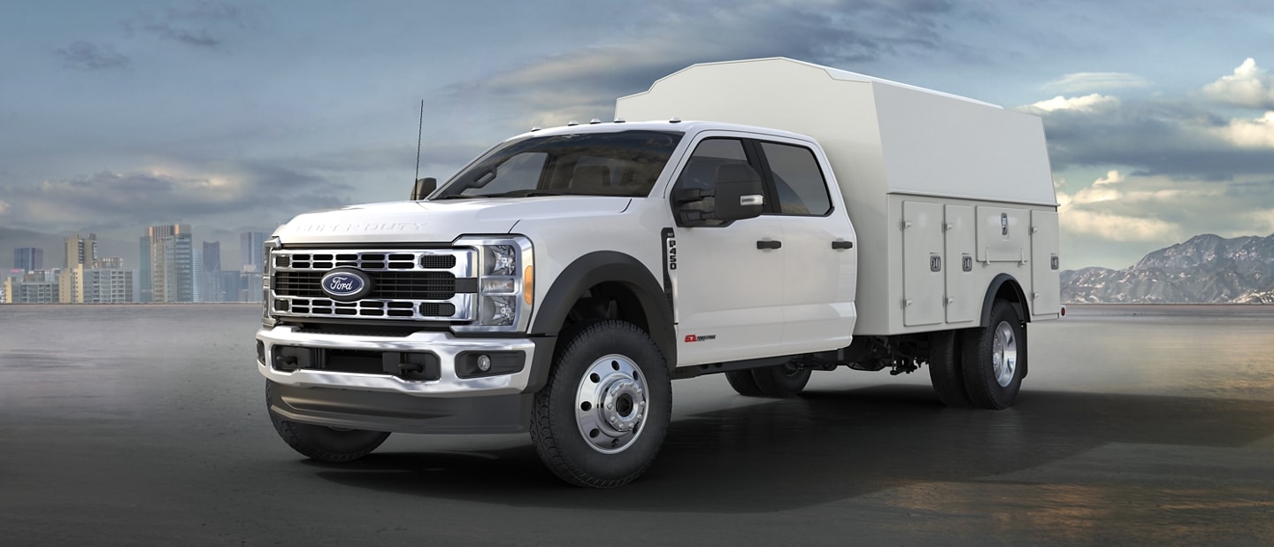 2023 Ford Super Duty® parked with enclosed box upfit with city and mountain in the background