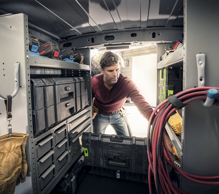 Interior view of a workman working in the back of a 2023 Ford Transit Connect Cargo Van