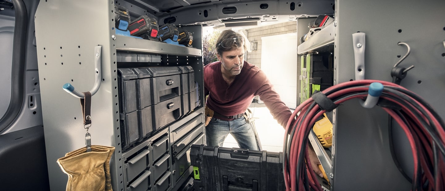 Interior view of a workman working in the back of a 2023 Ford Transit Connect Cargo Van