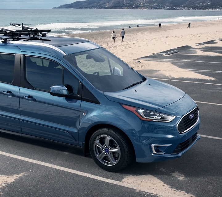 Available roof rack shown on Blue Metallic 2023 Ford Transit Connect Passenger Wagon parked at the beach