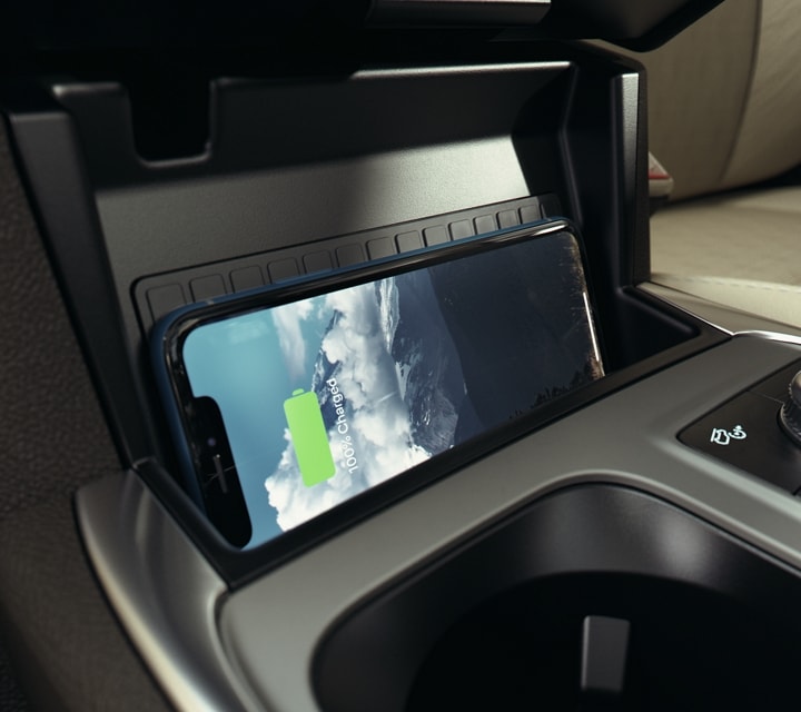 2022 Ford Explorer with tan interior close-up shot of wireless charging pad with phone charging