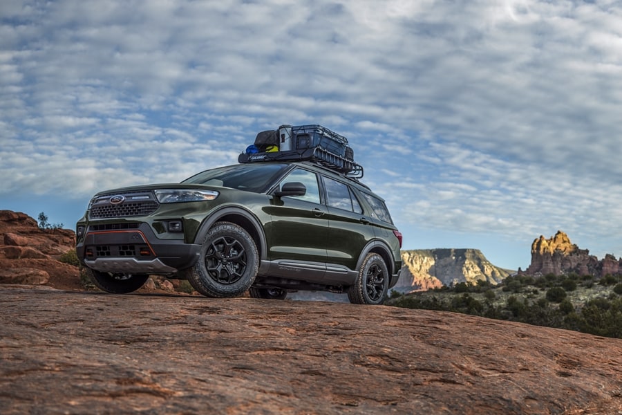 2023 Ford Explorer® with Outfitters Cargo - Mega Warrior roof rack filled with equipment parked in a desert.