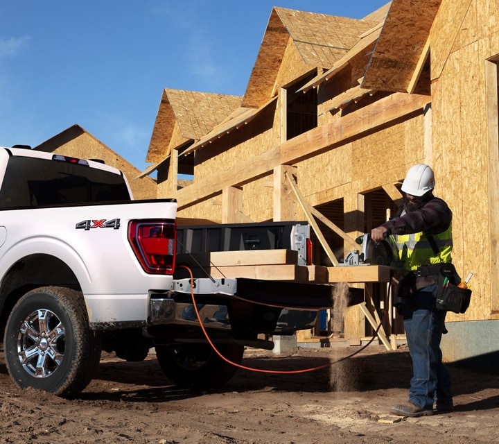 Construction workers working around a 2022 Ford F-150