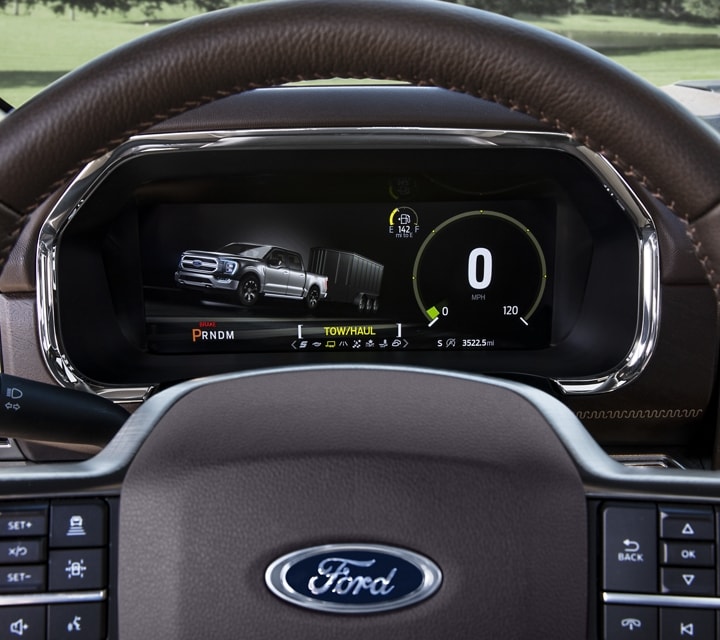 A close-up of the 2022 Ford F-150 steering wheel and dash showing the selectable drive modes
