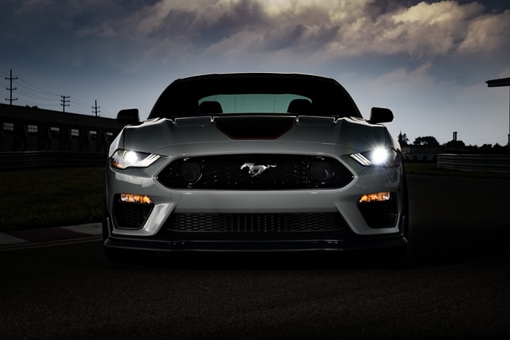A 2023 Ford Mustang® Mach 1® coupe at dusk with headlamps on