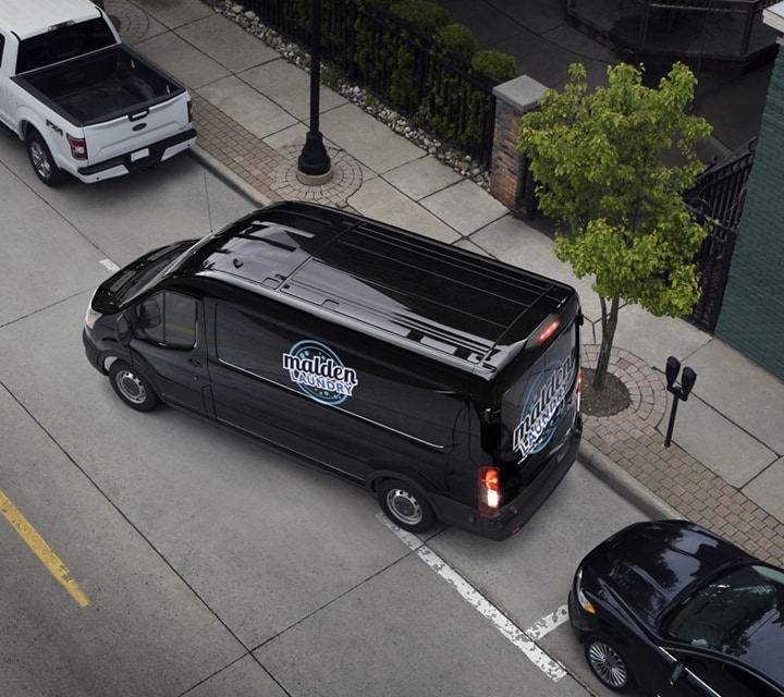 A 2023 Ford Transit® van being parallel parked