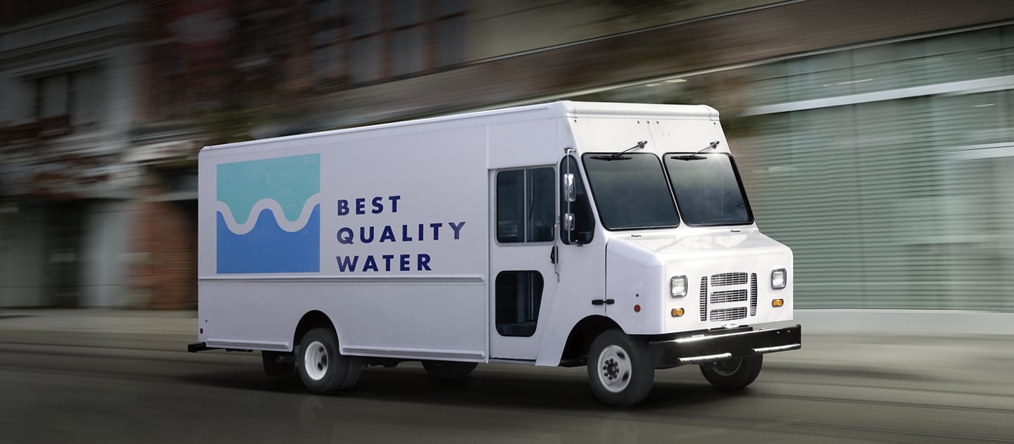 A commercial water delivery van being driven down the road