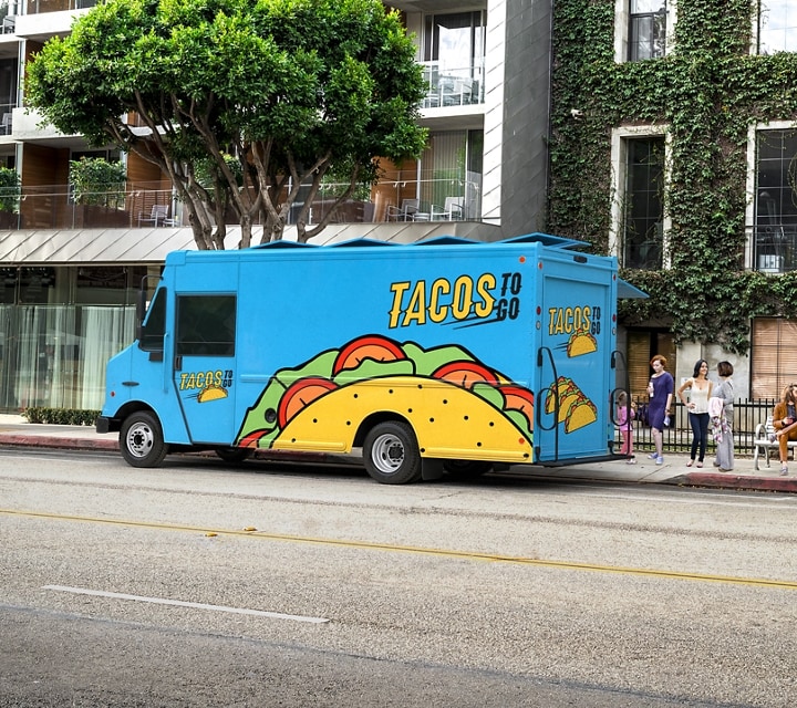 A taco truck parked in front of an apartment complex