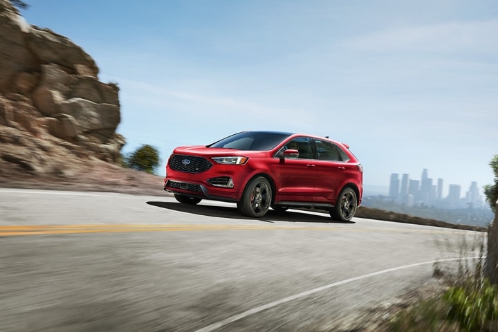 2023 Ford Edge® SUV being driven on a mountain road with city in background
