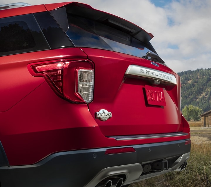 2023 Ford Explorer® King Ranch® model in Rapid Red Metallic Tinted Clearcoat extra cost color option showing a rear badge