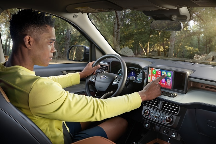 Man parked in 2023 Ford Maverick® truck using standard eight-inch touchscreen