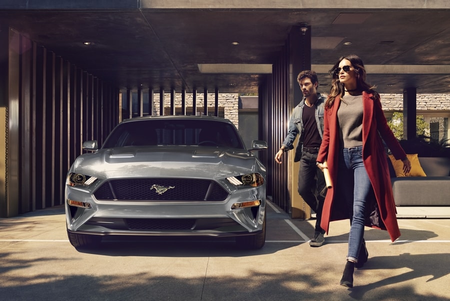 2023 Ford Mustang® 2.3L High Performance Package in Iconic Silver Metallic parked in garage with two people walking past
