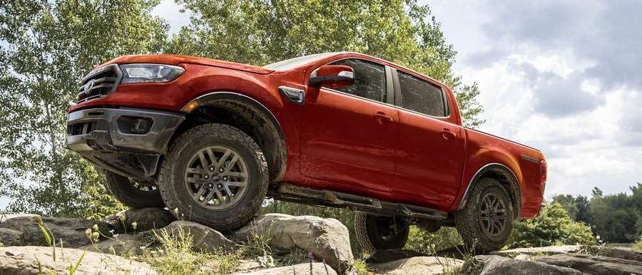 2023 Ford Ranger® Sport Lariat in Race red driving through dirt