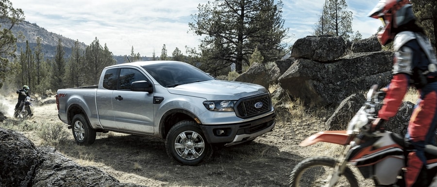 2023 Ford Ranger® parked on a trail with dirt bikes approaching