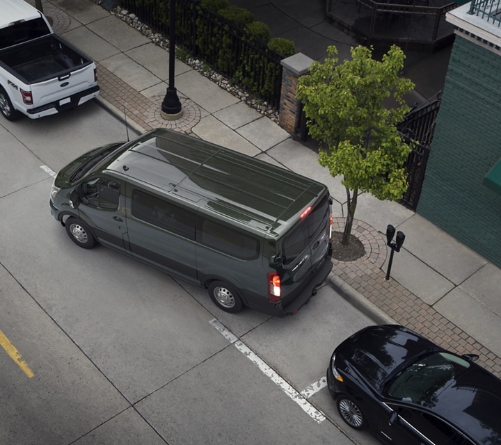 A 2023 Ford Ford Transit® van being parallel parked