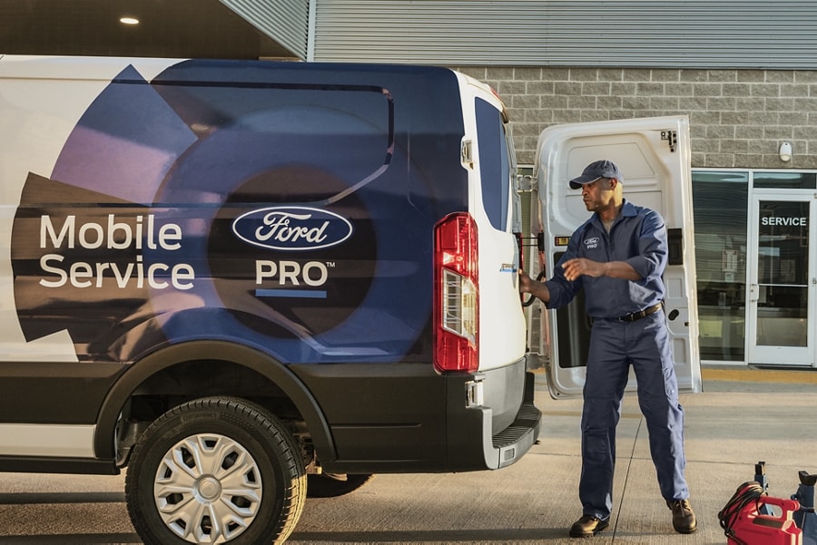 Man stands behind a 2023 Ford E-Transit™ Ford Pro™ truck
