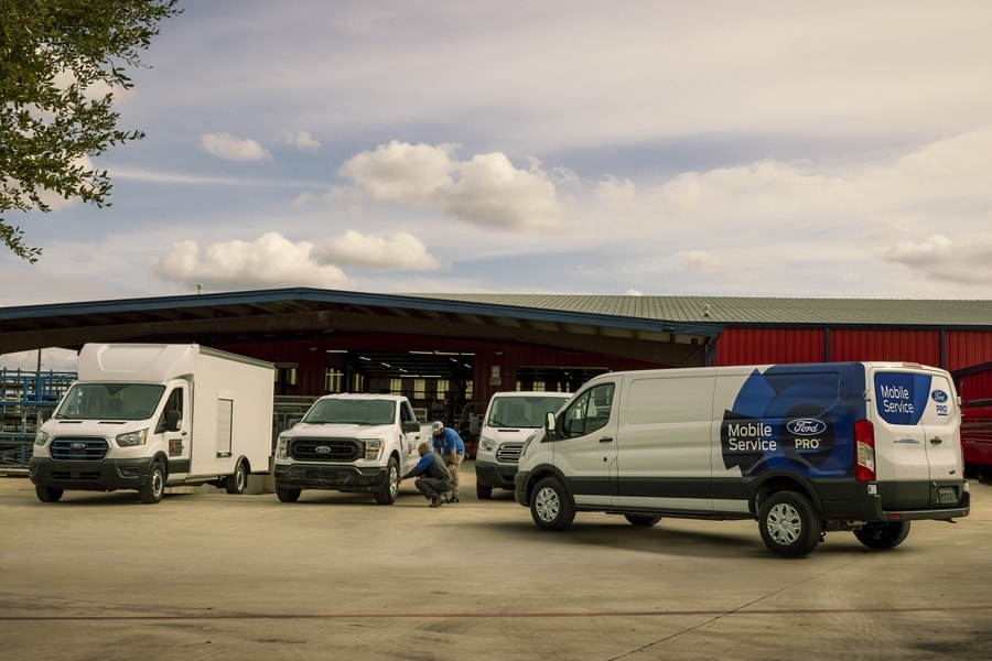 An array of Ford commercial vehicles outside of a Ford Pro™ Commercial Vehicle Center
