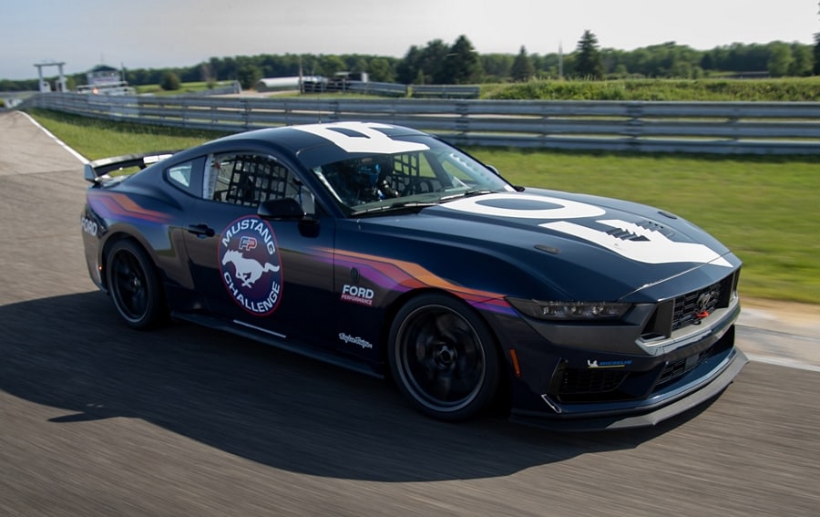 Ford Mustang® Dark Horse™ R race car being driven around a curve on a closed course
