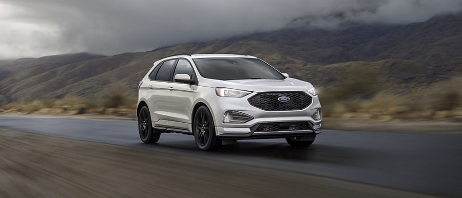 2023 Ford Edge® ST-Line model in Iconic Silver being driven on a desert road
