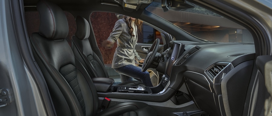 Interior of a 2023 Ford Edge® ST-Line as a woman enters the vehicle