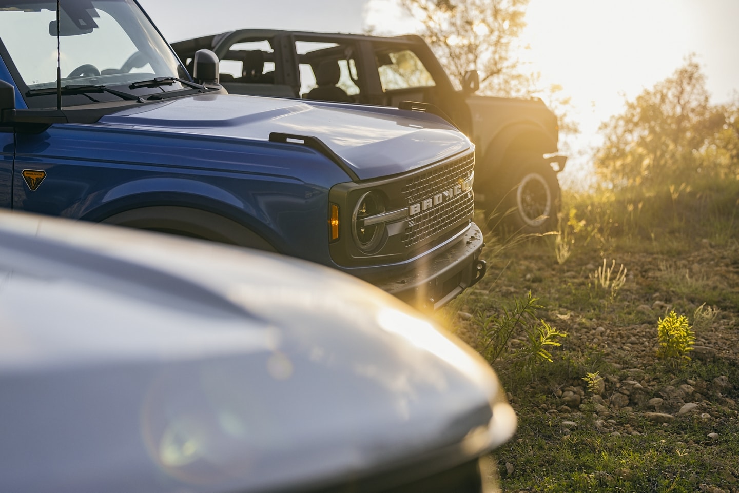 Several 2024 Ford Bronco® vehicles parked on the grass with the doors removed