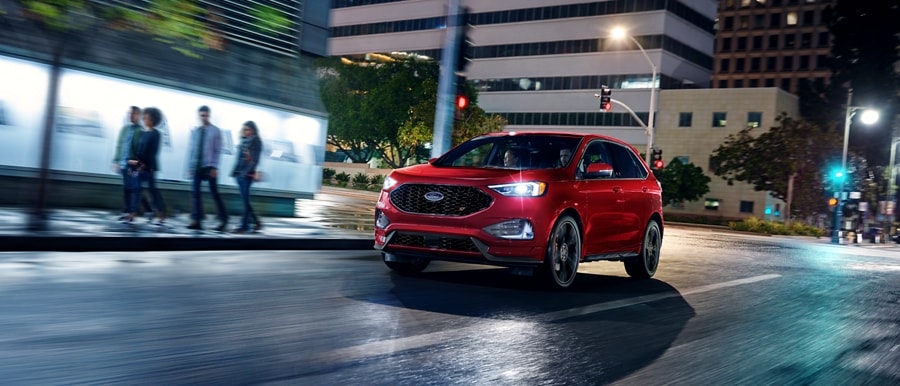 2023 Ford Edge® in Rapid Red being driven down a city street