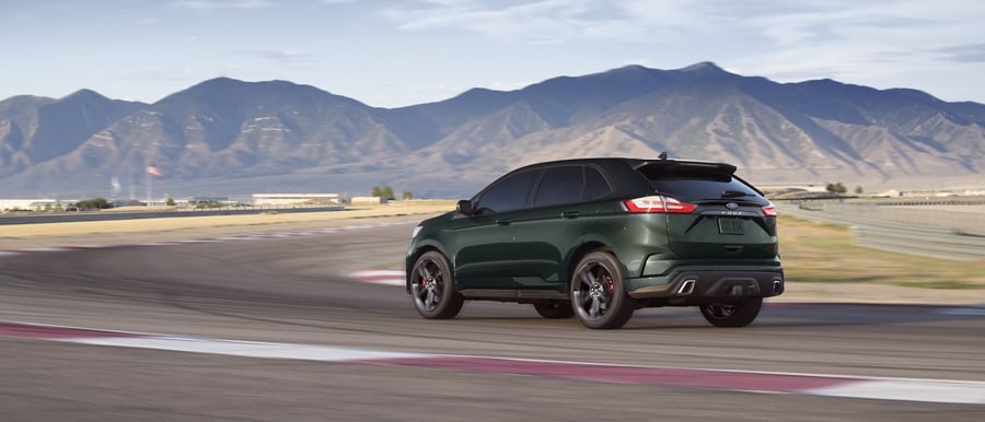2023 Ford Edge® in Forged Green being driven down a city street