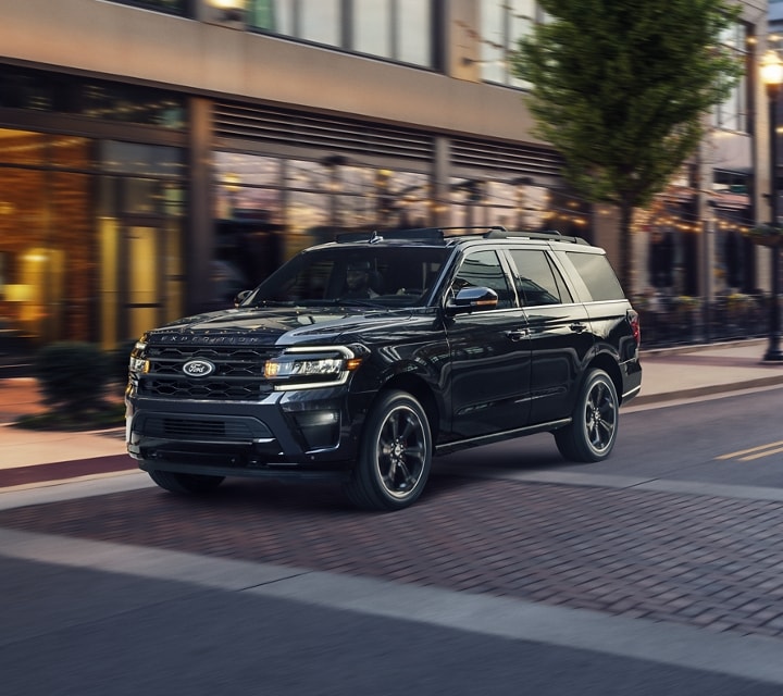 A 2024 Ford Expedition SUV being driven down a city street