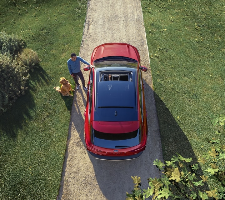 Overhead shot of a 2023 Ford Escape® Platinum in Rapid Red Metallic Tinted Clearcoat (extra cost paint) parked in a driveway.