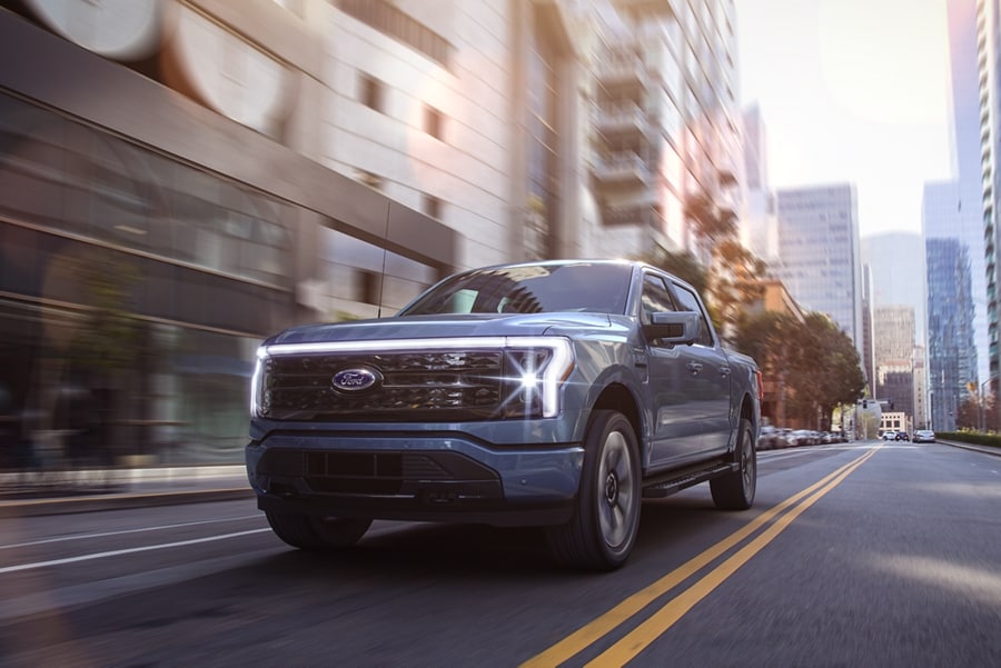 A 2023 Ford F-150® Lightning® being driven in the city