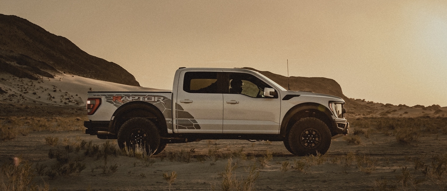 2023 Ford F-150® Raptor® R being driven in the desert kicking up dust