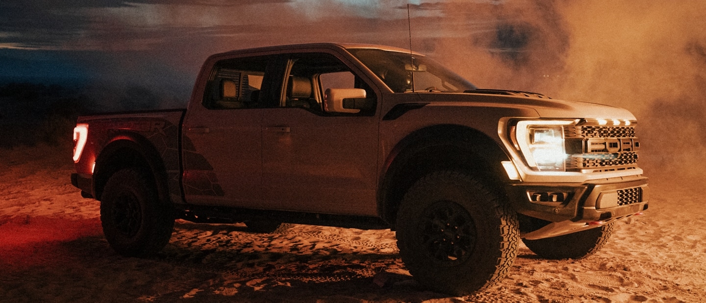 Image of the 2023 Ford F-150® Raptor R™ parked in desert with dust blowing