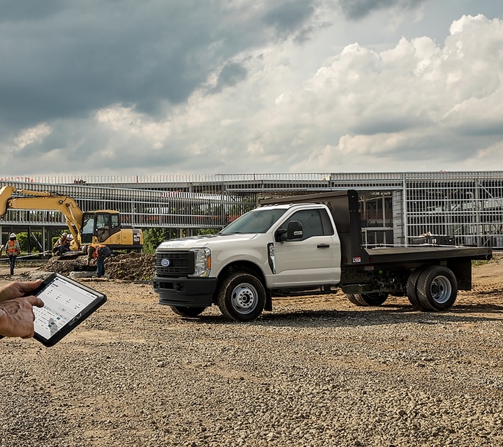 2023 Ford Super Duty® shown on job site with flatbed upfit