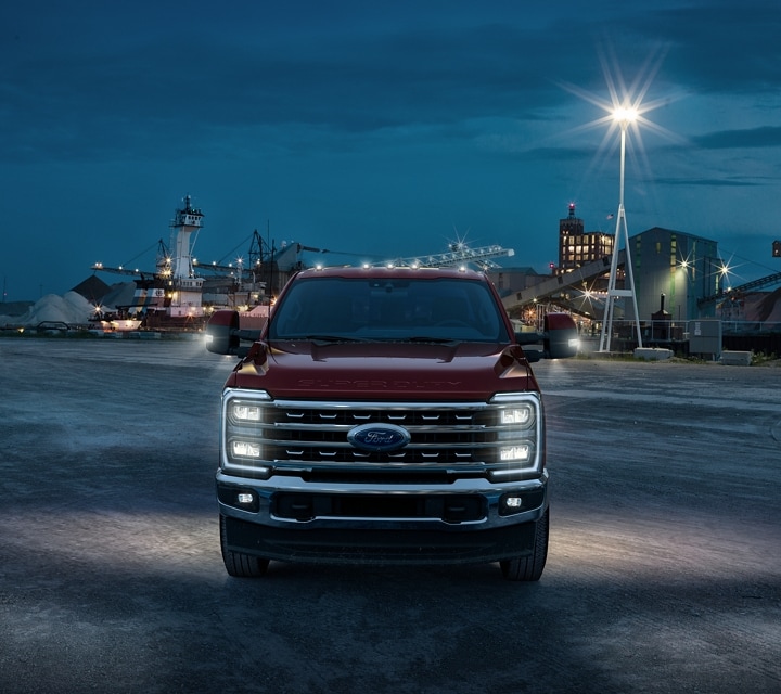2023 Ford Super Duty® parked at a building site at night with headlights illuminated