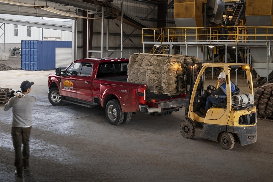 2023 Ford Super Duty® F-350® LARIAT being loaded with a pallet of hay bales