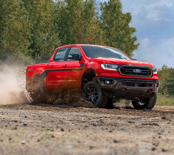2023 Ford Ranger® SuperCrew® in Race Red kicking up dirt on a trail