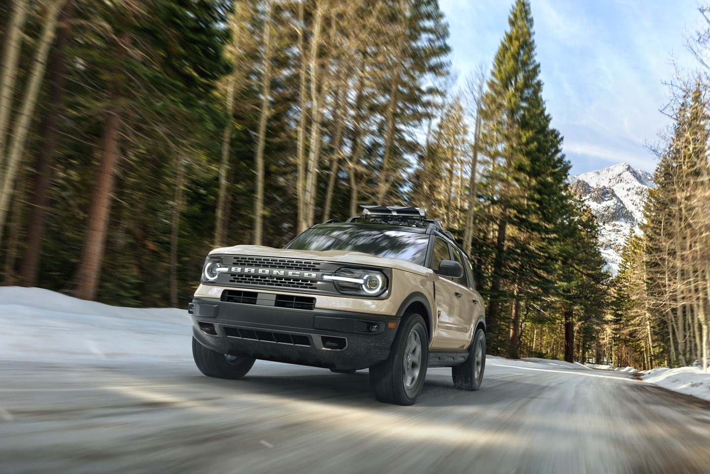 2024 Ford Bronco® Sport being driven down a tree-lined road