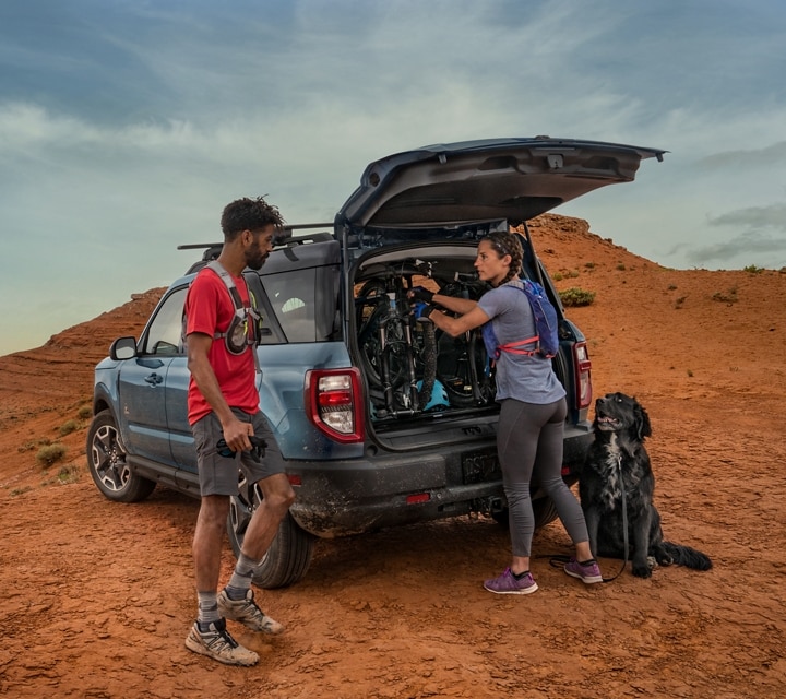 Two people standing outside a 2024 Ford Bronco® Sport with cargo in the back
