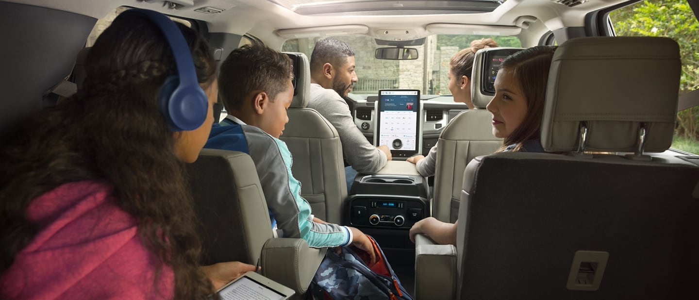 A family of five sitting in a 2024 Ford Expedition using the available technology