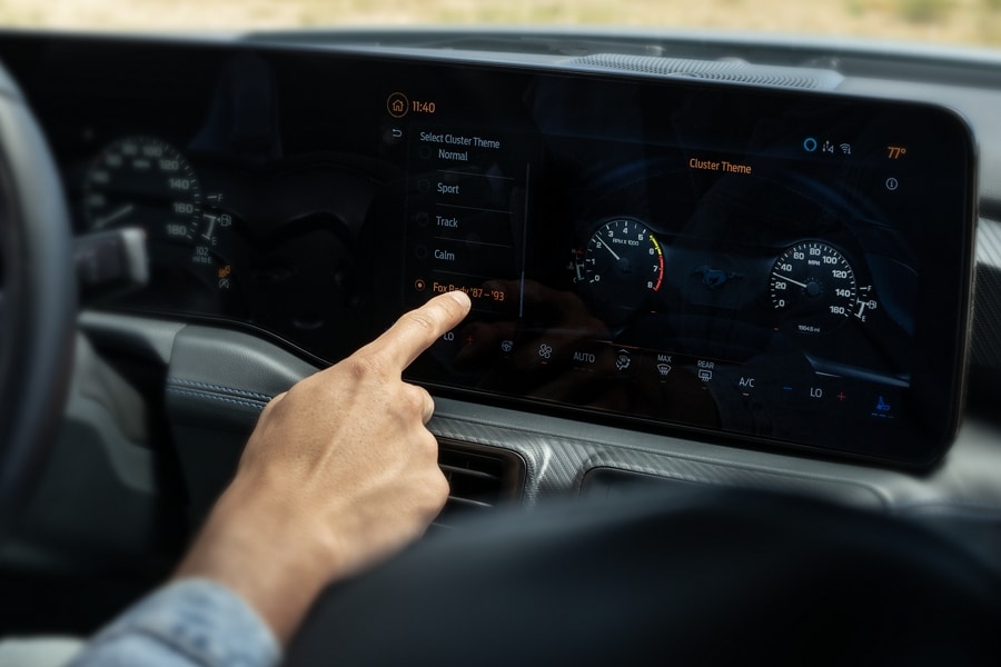 Person using the touchscreen in a 2024 Ford Mustang® model