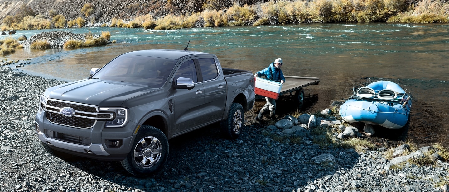 A 2024 Ford Ranger® LARIAT is parked at a lake with fishing gear being unloaded