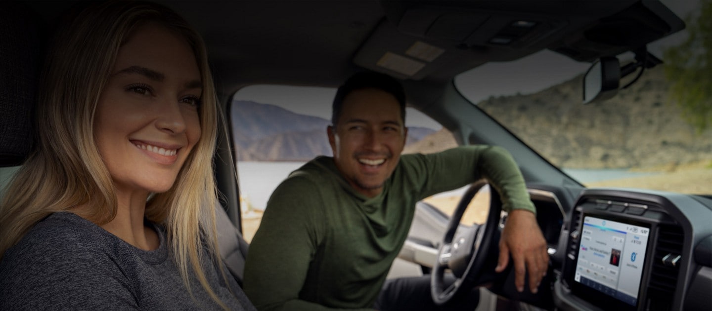 Two people sitting in the interior of an F150® Lightning
