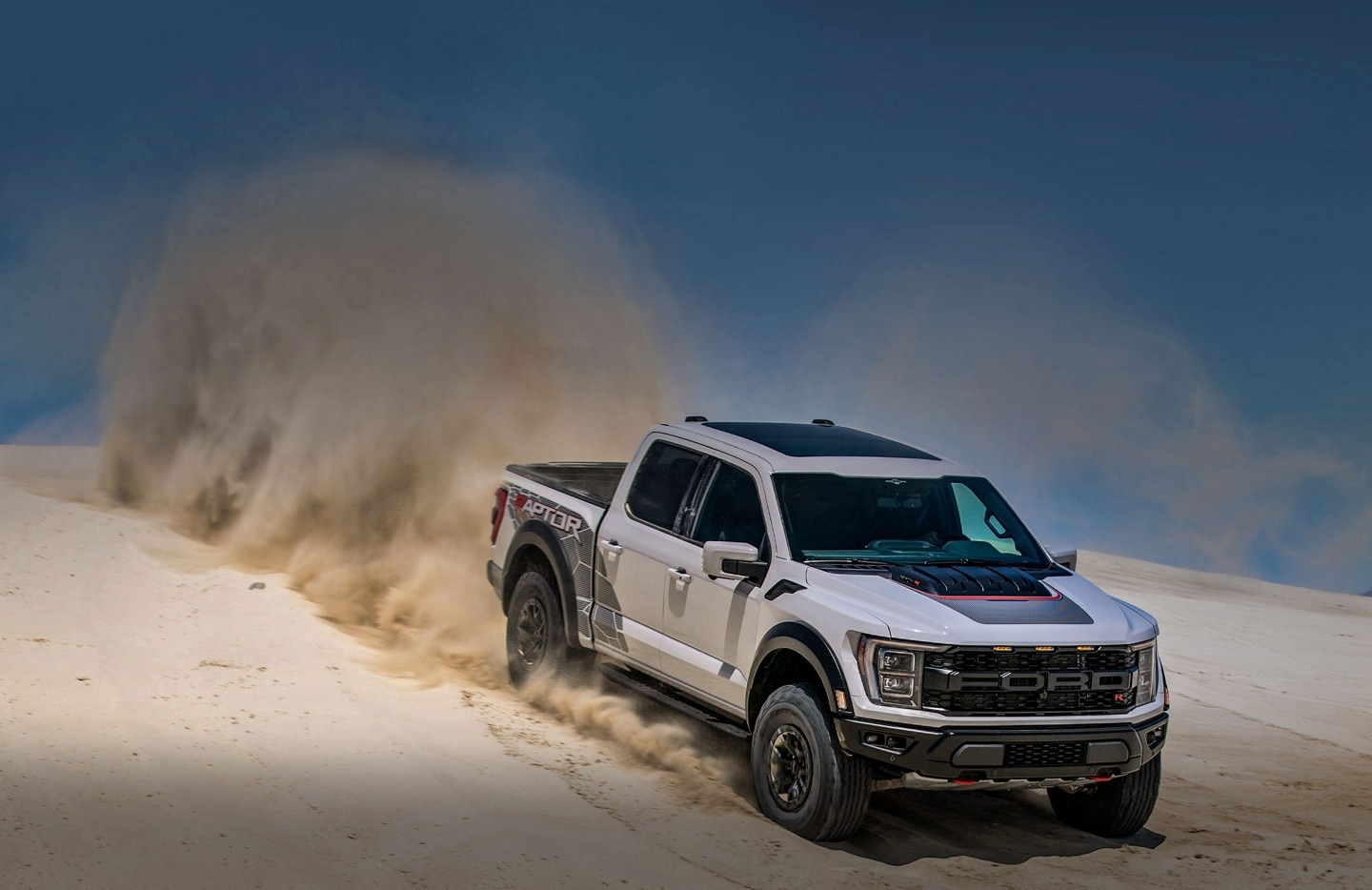 2023 Ford F-150® Raptor R™ being driven over sand dunes in the desert