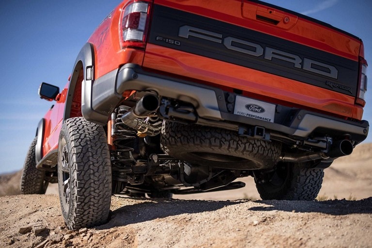 Close-up of rear suspension as 2022 F-150® Raptor® is driven over rough terrain