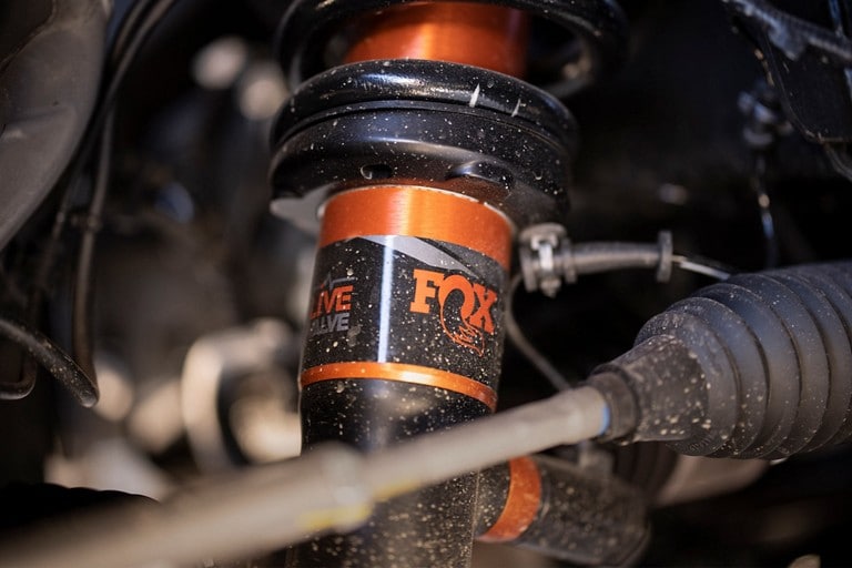 Close-up of FOX™ Live Valve™ shocks installed on the 2022 Ford F-150® Raptor®
