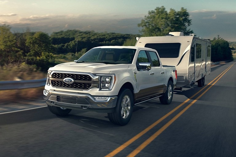 2023 Ford F-150® towing a trailer down a road
