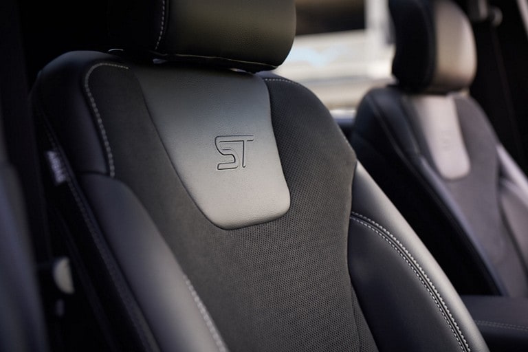 Close-up of ST bolstered bucket seat with City Silver stitching and embossed ST logo